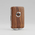 Wooden key fob with Volvo logo on a gray background