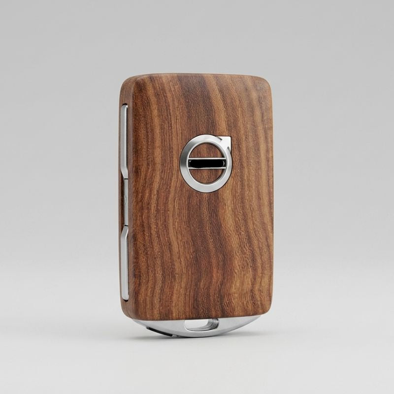 Wooden key fob with Volvo logo on a gray background