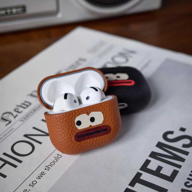 Cool Handmade Leather AirPods Pro 3 Case iWoodStore Brown leather case with white earbuds on a newspaper background
