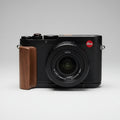Leica camera with a wooden grip on a gray background