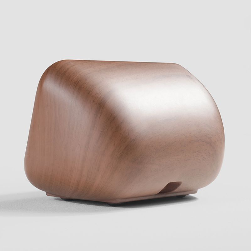 Wooden cube-shaped object on a light gray background