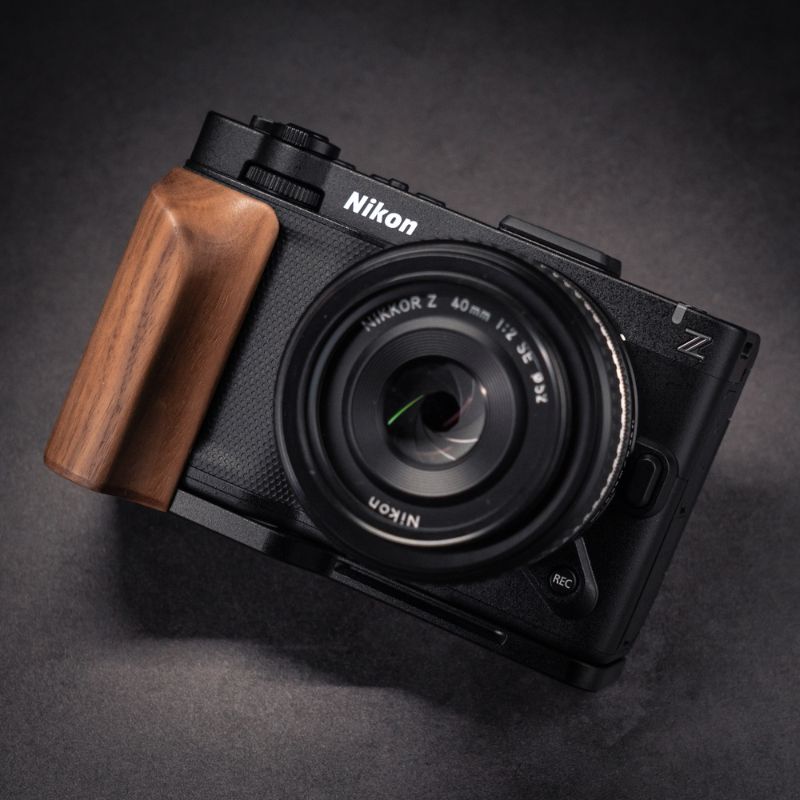 Nikon ZR camera with wooden grip on a dark background