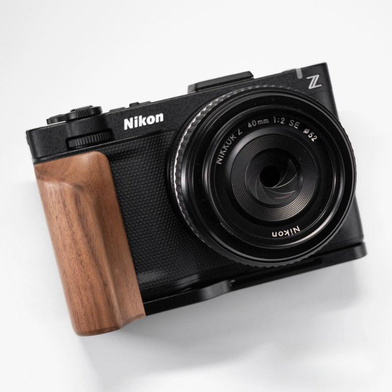 Nikon ZR camera with wooden grip on a white background