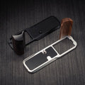 YW Design Handcrafted Wooden Grip for OM-System PEN A close-up of a knife or tool handle replacement set on a dark wood-textured background, showing a black textured handle grip with a dark wood handle section and a silver metal guard with a black grip insert.