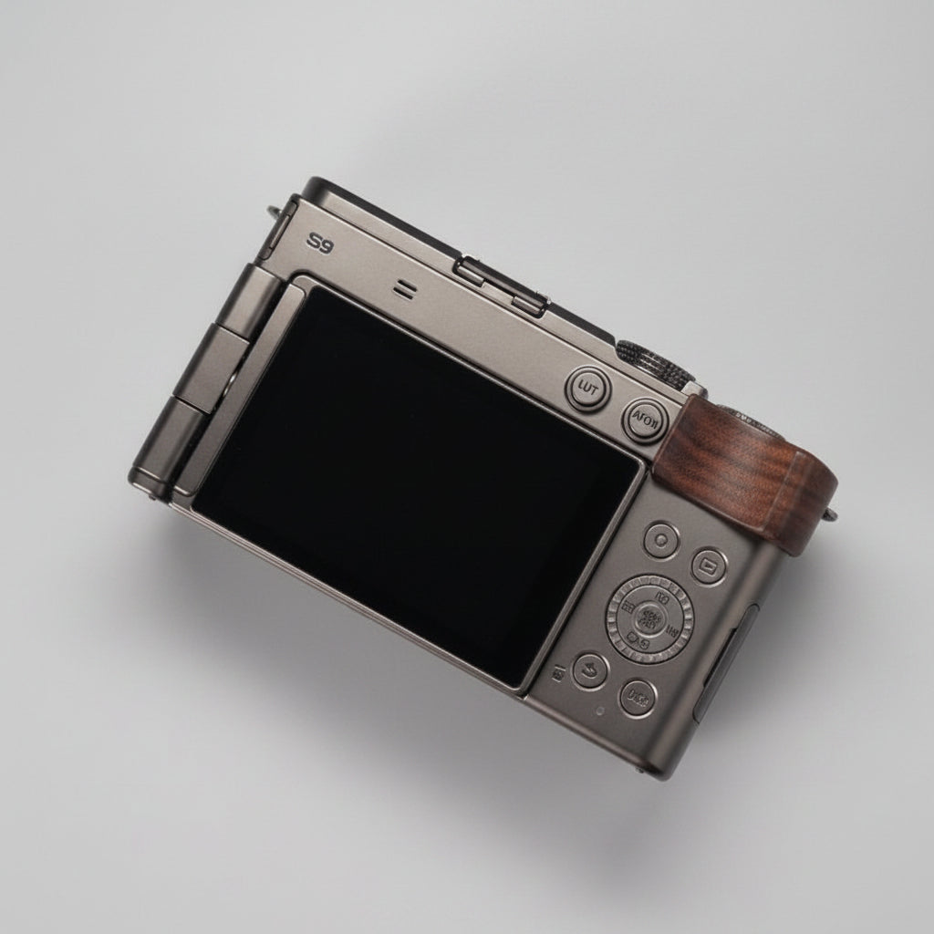Close-up of a camera with wooden grip on a dark background