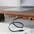 Wood Telescopic Retractable Data Cable Charging Cable For Desk iWoodStore USB cable with orange clips on a desk setup with a laptop and keyboard.
