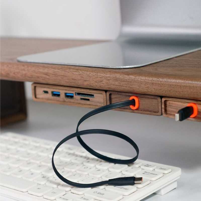 Wood Telescopic Retractable Data Cable Charging Cable For Desk iWoodStore USB cable with orange clips on a desk setup with a laptop and keyboard.